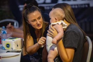 Topdrill team member playing with a small child at the Topdrill christmas party