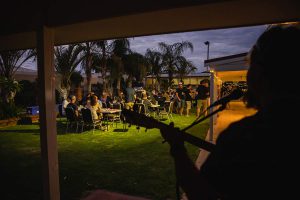 Photo from behind the musician looking out towards the guests at the Topdrill Christmas party