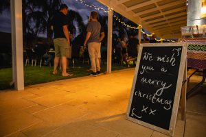 Image of a chalkboard placed at the entry of the Topdrill Christmas party with the words we wish you a merry christmas