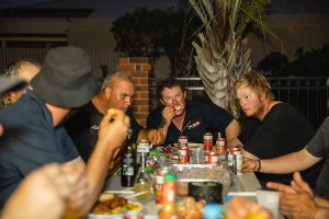 Candid image of three Topdrill team members enjoying conversation at the Christmas party