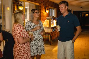 three Topdrill team members celebrating and conversing together at the christmas party event