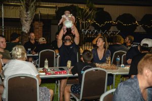 Topdrill team member throwing baby up into the air at the Christmas party event