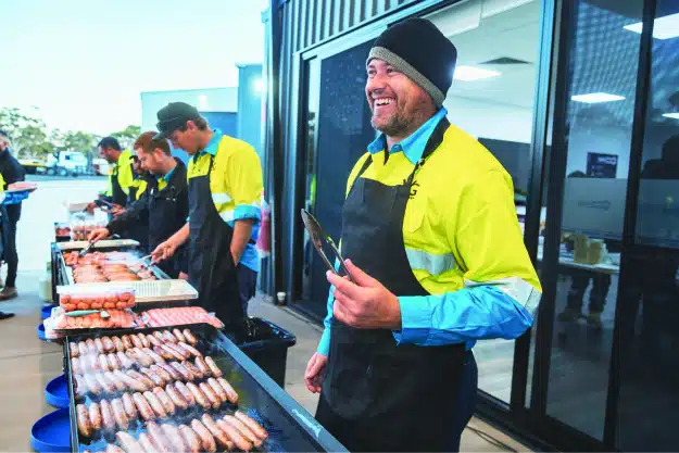 Image of Topdrill team members cooking breakfast at the R U OK? Day event hosted by Topdrill